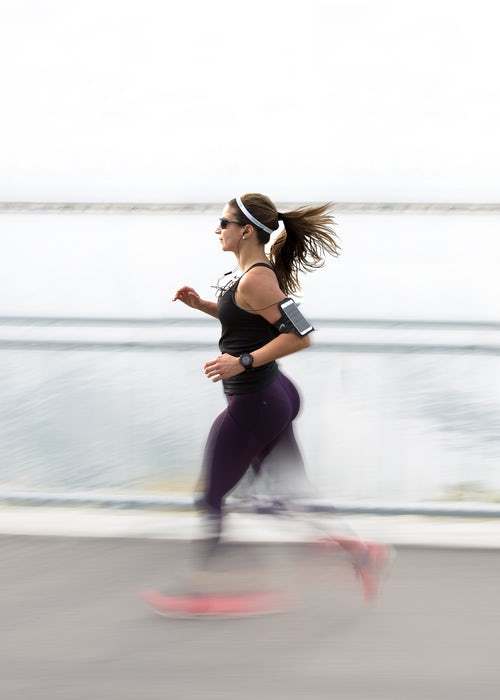 running woman with arm band- Photo by Filip Mroz on Unsplash